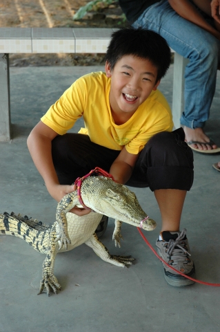 Cameron holding a baby Croc